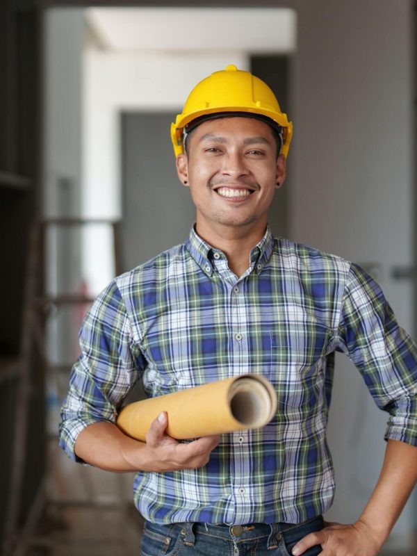 architect-man-working-with-blueprints-for-architectural-plan-engineer-sketching-a-construction.jpg
